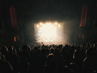 Silhouetted Crowd Watching Bright Concert Stage Performance