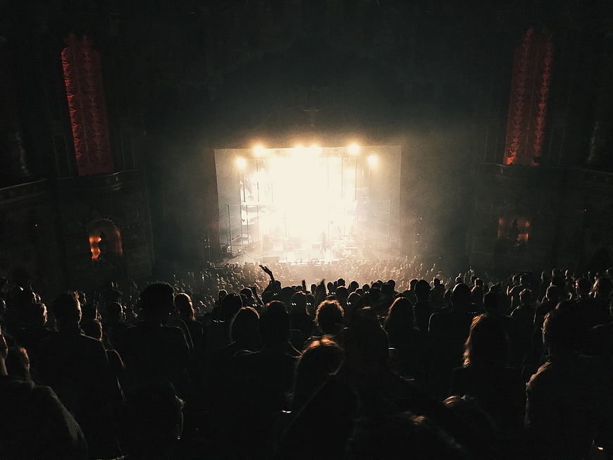 Silhouetted Crowd Watching Bright Concert Stage Performance
