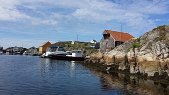 Norwegian coastal village with boats and rocky cliffs