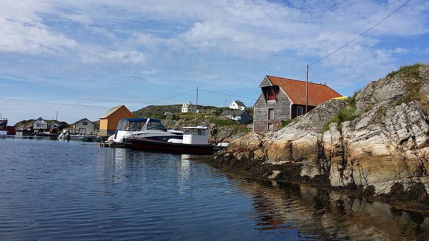 Norwegian coastal village with boats and rocky cliffs