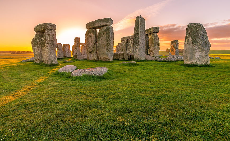 Stonehenge Sunrise Landscape with Green Grass and Golden Sky
