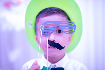 Cute boy with party props and green hat