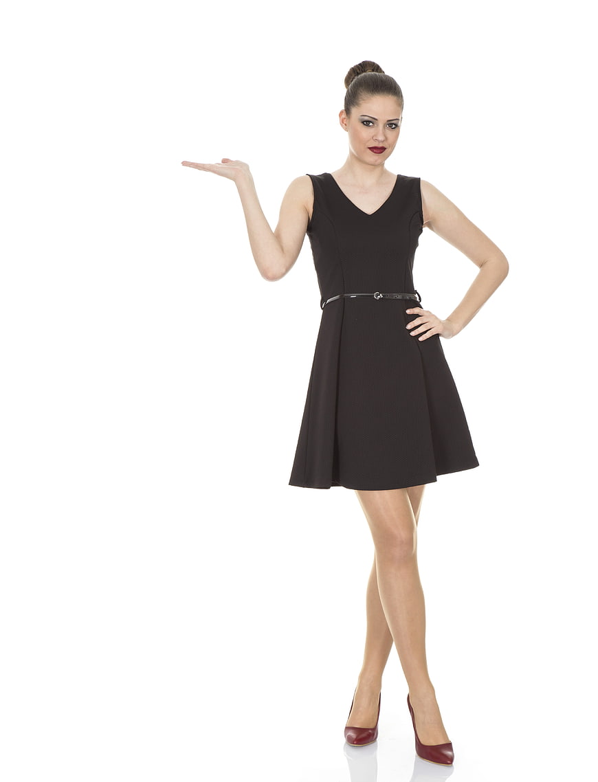 Woman in Black Dress Gesturing with Hand on White Background
