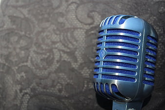 Close-up of vintage blue microphone with silver grille