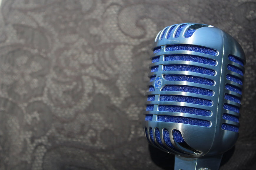 Close-up of vintage blue microphone with silver grille
