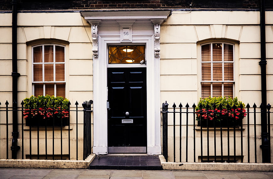 Classic London Townhouse with Black Door and Flower Boxes
