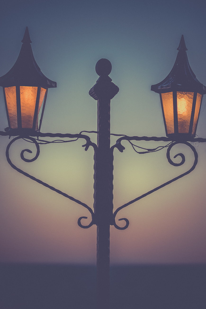 Silhouette of ornate street lamp against twilight sky