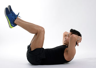 Man doing bicycle crunches exercise on white background