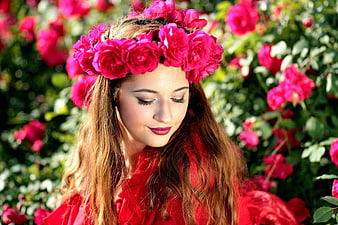 Woman with pink rose wreath in garden