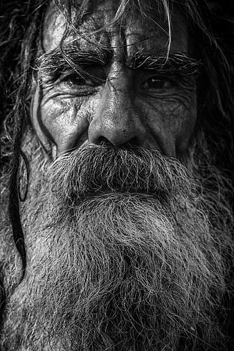 Close-up black and white portrait of elderly bearded man
