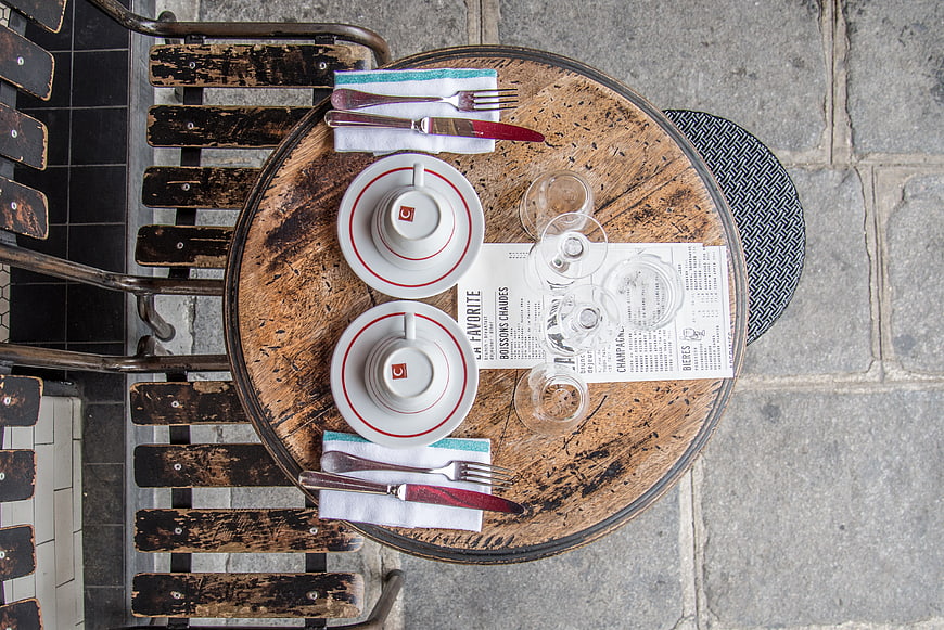 Top view of rustic cafe table set for two in Paris