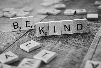 Be Kind Scrabble Tiles on Wooden Background