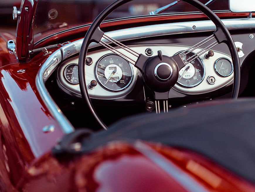 Vintage Red Convertible Interior with Chrome Steering Wheel
