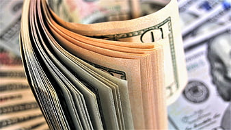 Close-up of fanned US dollar bills with shallow depth of field