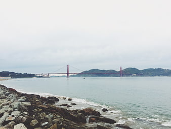 Golden Gate Bridge View from Rocky Shore on Overcast Day