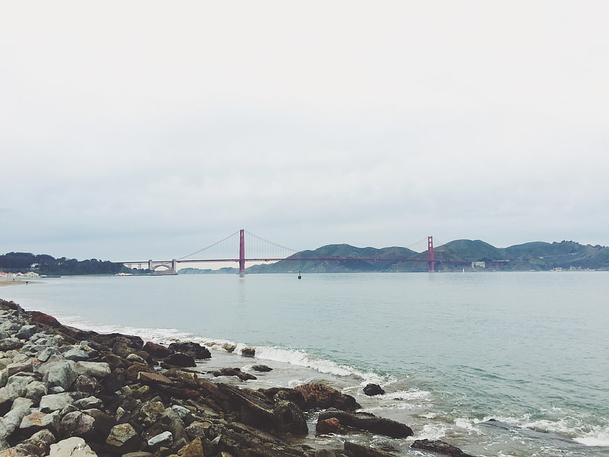 Golden Gate Bridge View from Rocky Shore on Overcast Day