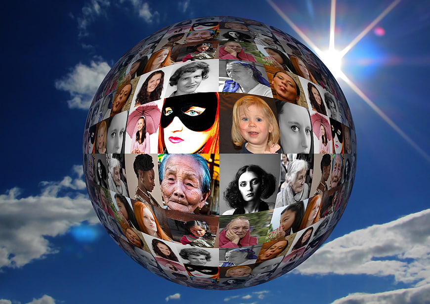 Global Sphere of Diverse Women's Faces Against Blue Sky