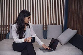 Professional Woman Working on Laptop with Coffee