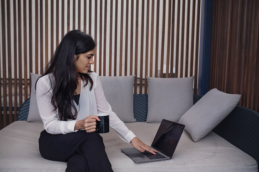 Professional Woman Working on Laptop with Coffee