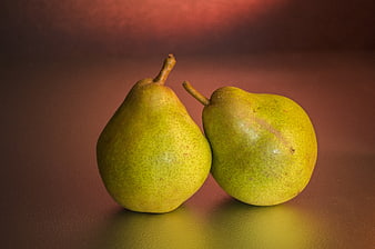 Two Green Pears on Dark Brown Background