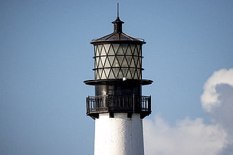 White Lighthouse Tower Top Against Blue Sky