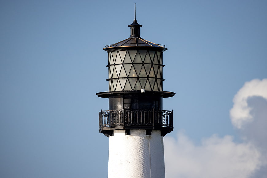 White Lighthouse Tower Top Against Blue Sky