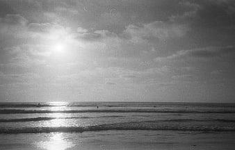 Vintage Black and White Film Photo of Ocean Waves and Sunlight