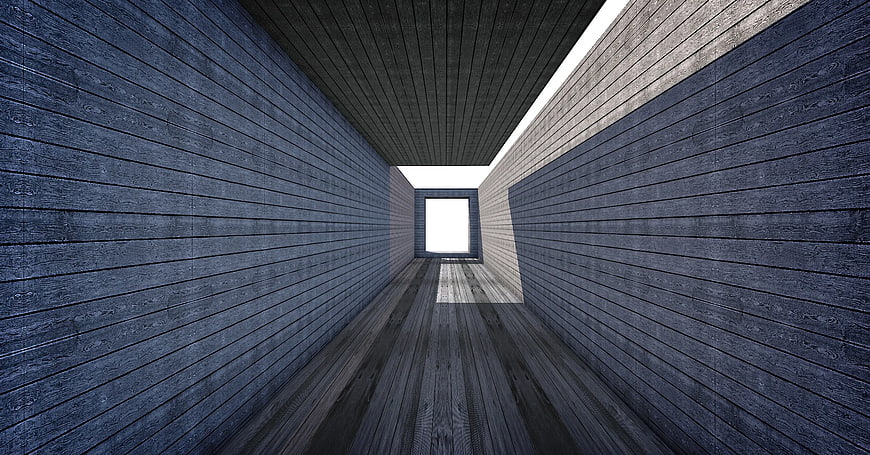 Modern gray wooden tunnel with bright light at the end