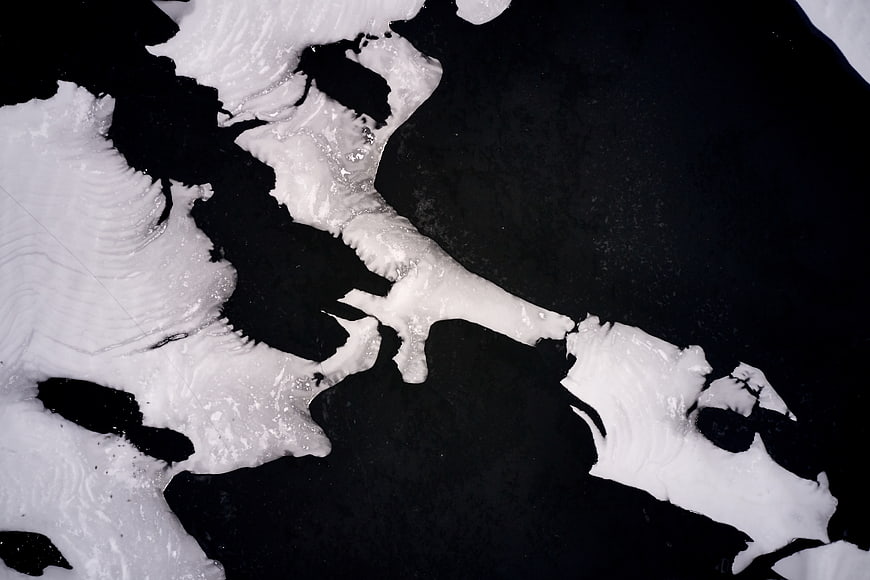 Abstract black and white ice texture pattern on dark water