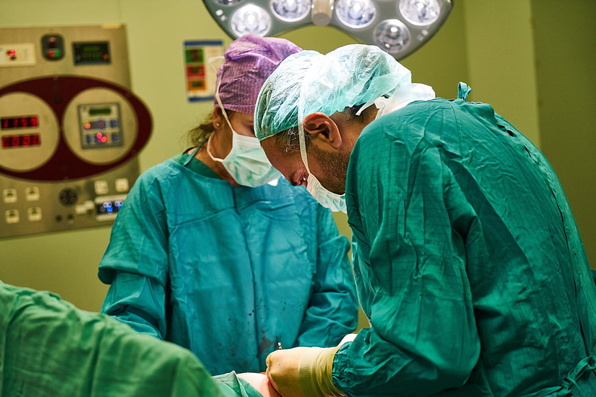 Surgeons performing surgery in operating room