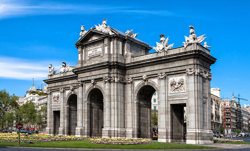 Puerta de Alcalá monument in Madrid, Spain under blue sky