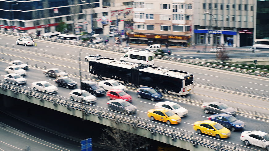 High Angle View of Busy City Highway Traffic with Articulated Bus