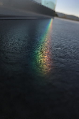 Rainbow Light Spectrum Reflection on Dark Textured Surface