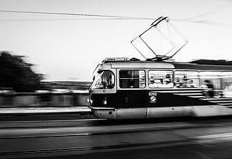 Vintage black and white tram in motion with motion blur