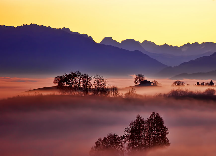 Misty Mountain Landscape at Sunrise with Foggy Valley
