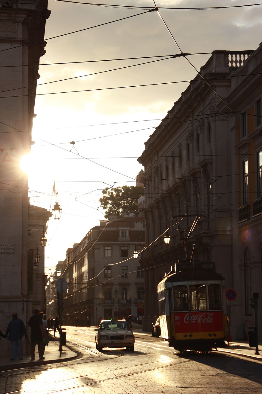 Vintage yellow tram on Lisbon street at golden hour