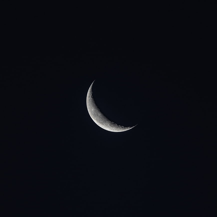Crescent moon in dark night sky