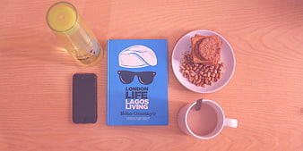 Flat lay of book, coffee, snacks, and smartphone on wooden table
