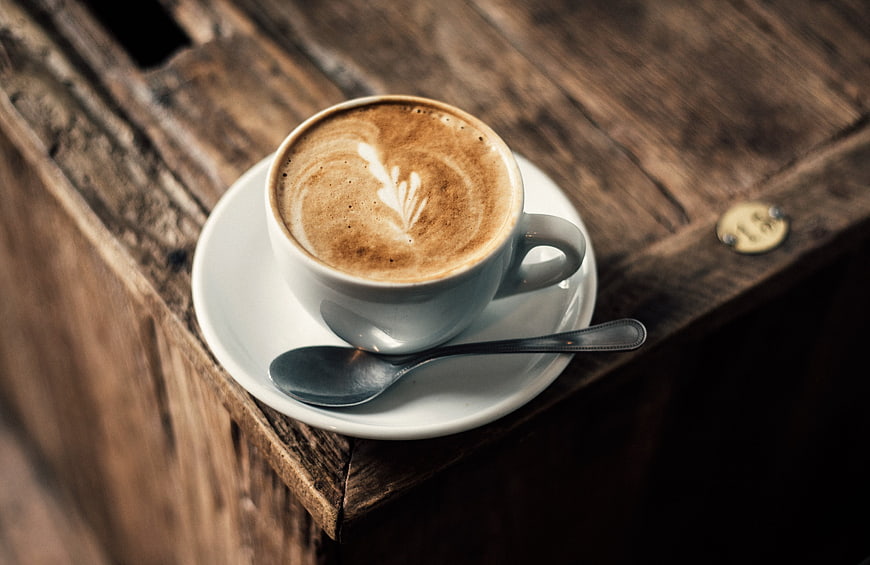 Latte Art Coffee Cup on Rustic Wooden Table