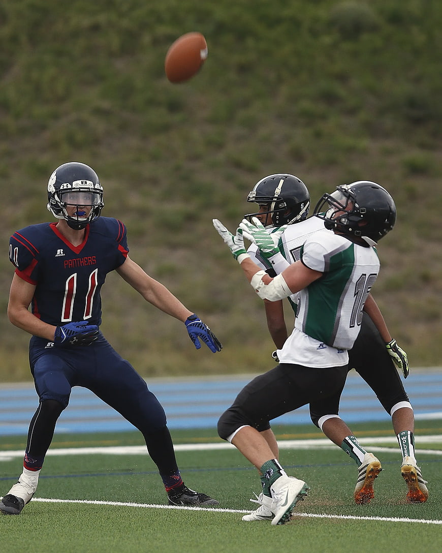 American Football Players Catching Ball in Action