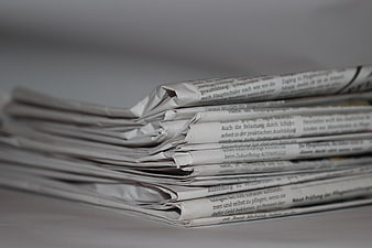 Stack of folded newspapers with German text