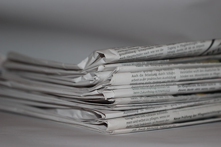 Stack of folded newspapers with German text