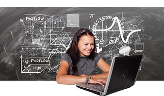 Smiling girl studying math on laptop with chalkboard background