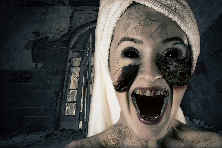 Horror woman with black eyes screaming in abandoned building