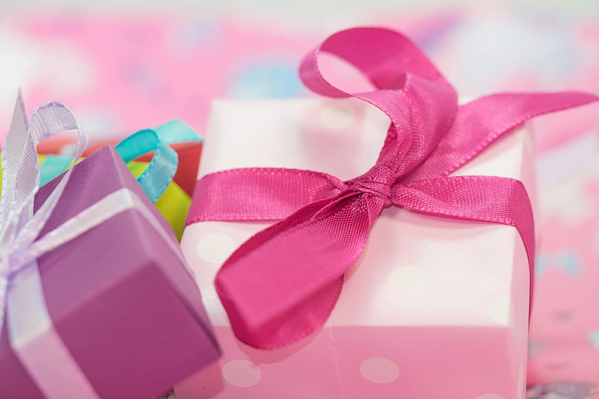 Colorful Gift Boxes with Ribbons on Blurred Background