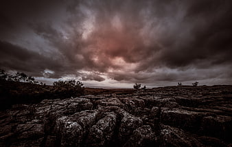 Dramatic moody limestone pavement landscape under stormy clouds