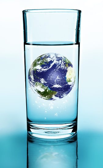 Glass of Water with Earth Globe Inside Concept
