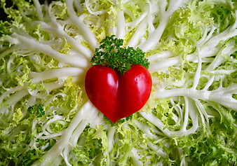 Heart-shaped red pepper on frisée lettuce bed