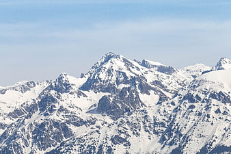 Majestic Snow-Covered Mountain Peaks Under Blue Sky