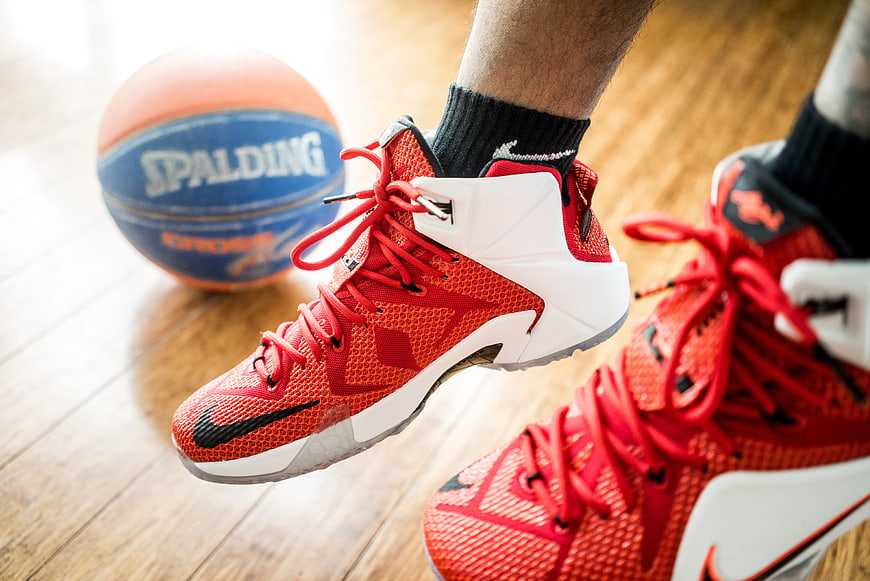 Close-up of red Nike basketball shoes on hardwood court